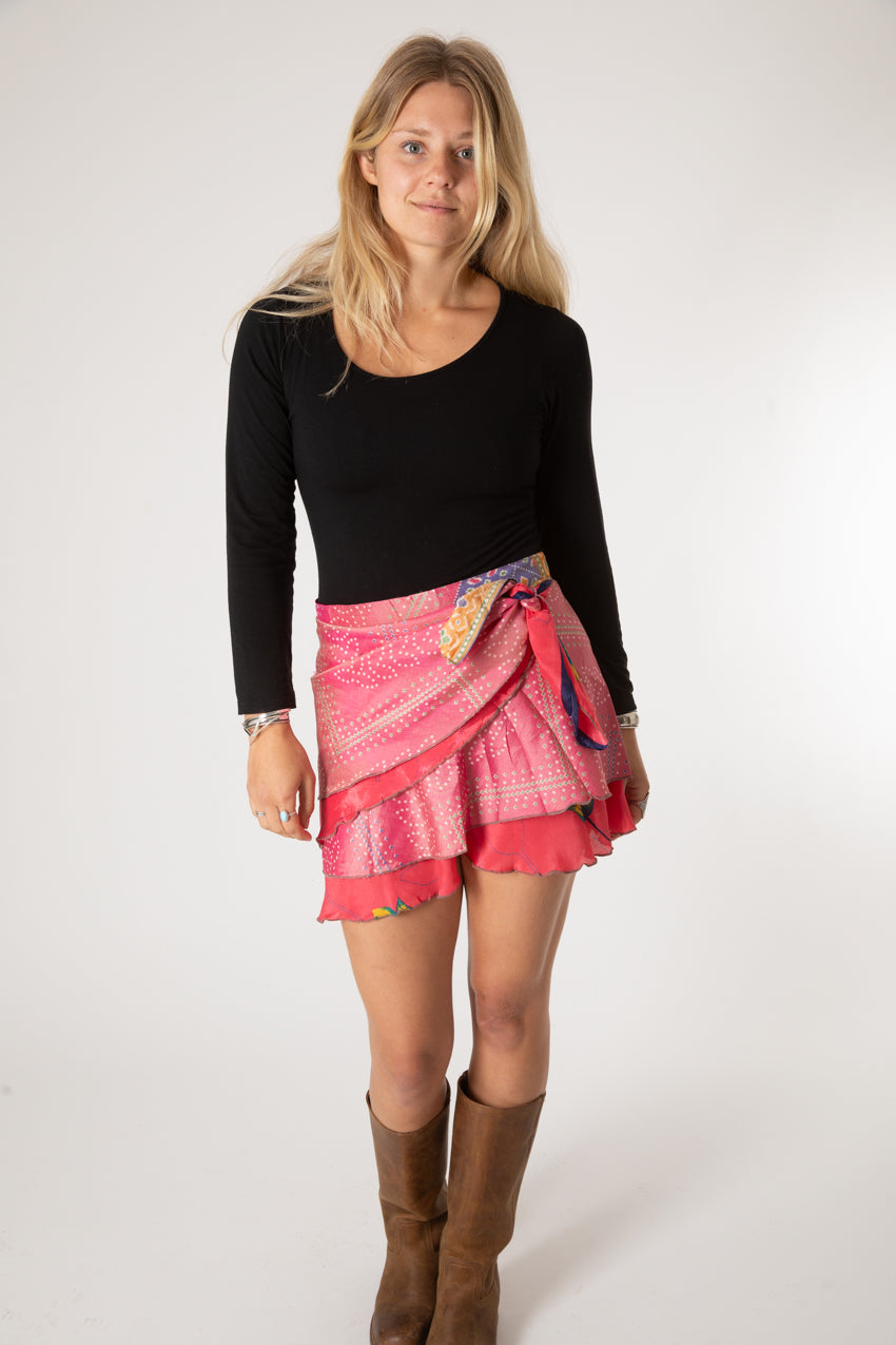 Sophie is wearing a silk wrap skirt in sugar magnolia