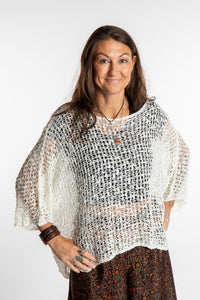 Jen wearing a ivory lightweight knitted poncho