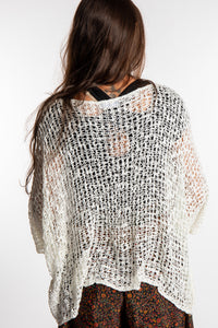 Jen wearing a ivory lightweight knitted poncho