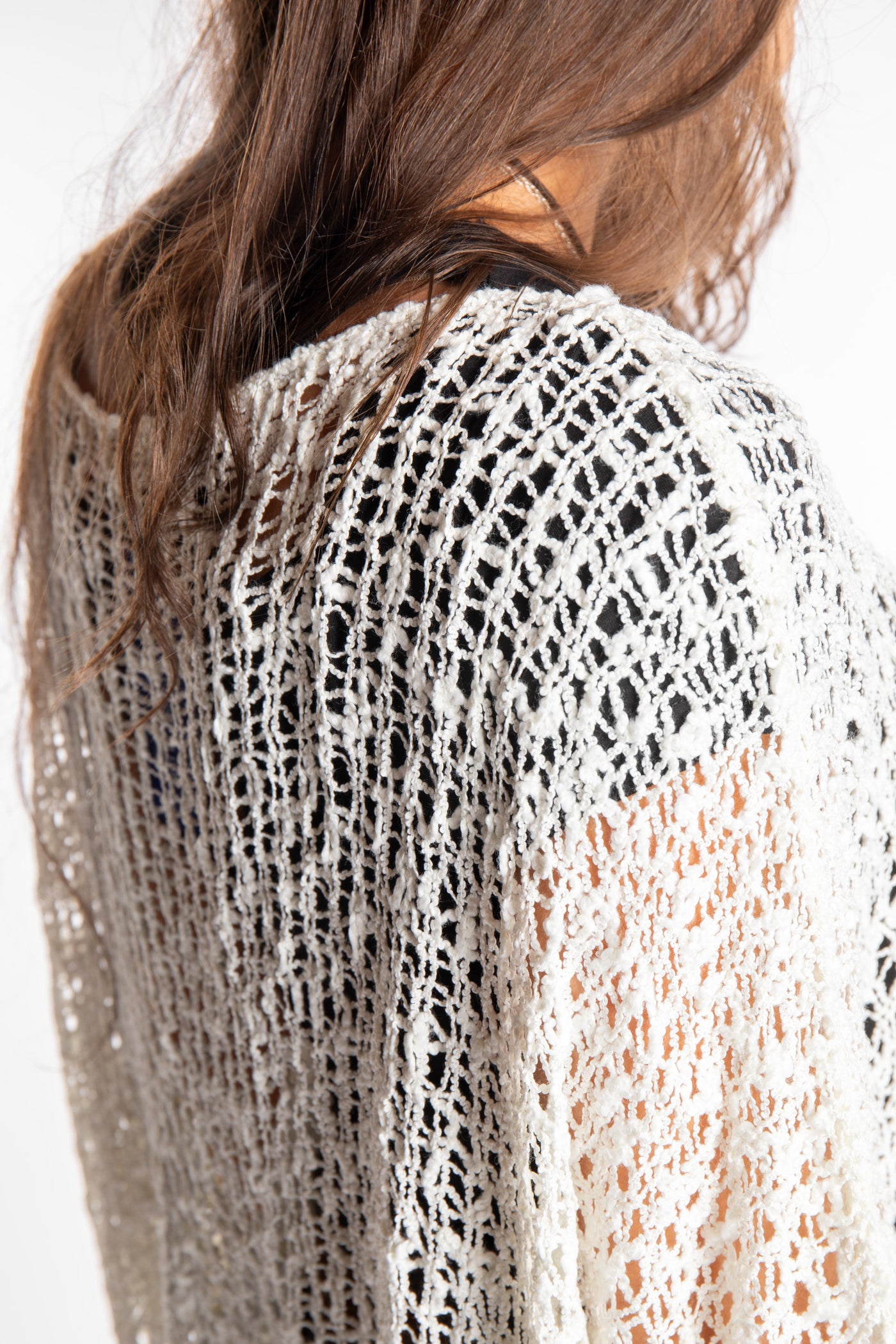 Jen wearing a ivory lightweight knitted poncho