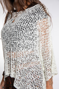 Jen wearing a ivory lightweight knitted poncho