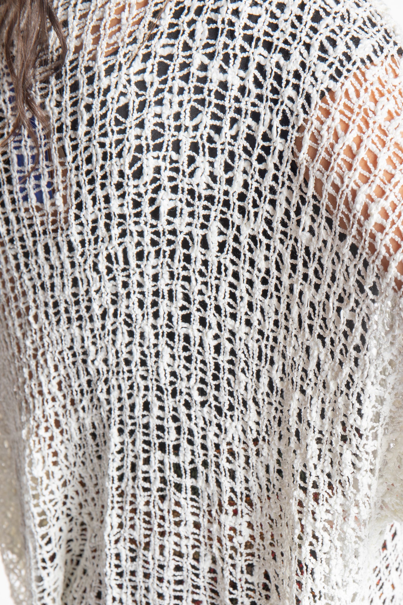 Jen wearing a ivory lightweight knitted poncho