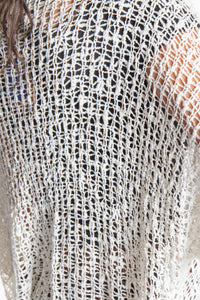 Jen wearing a ivory lightweight knitted poncho