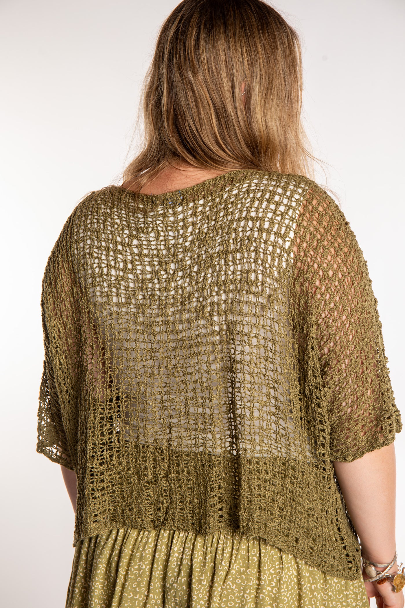 Emma wearing a Olive lightweight knitted poncho