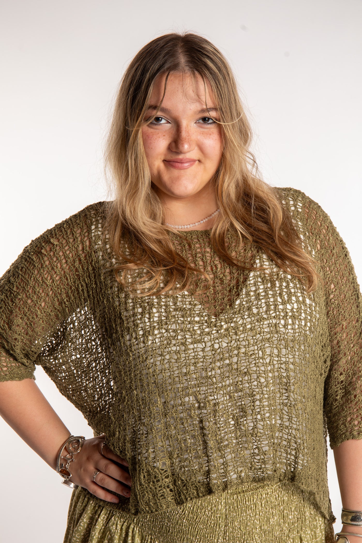 Emma wearing a Olive lightweight knitted poncho