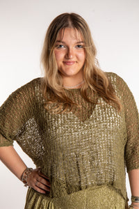 Emma wearing a Olive lightweight knitted poncho