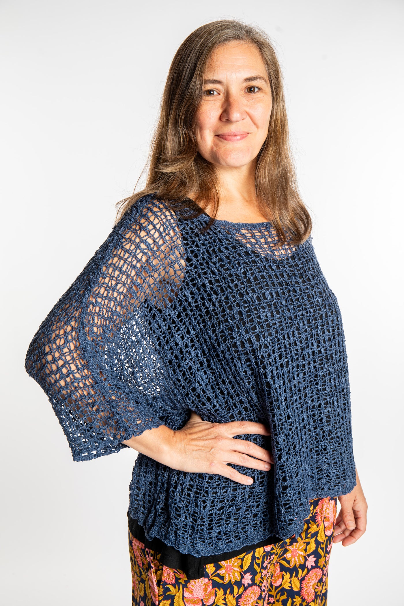 Holly wearing a Pacific Blue lightweight knitted poncho