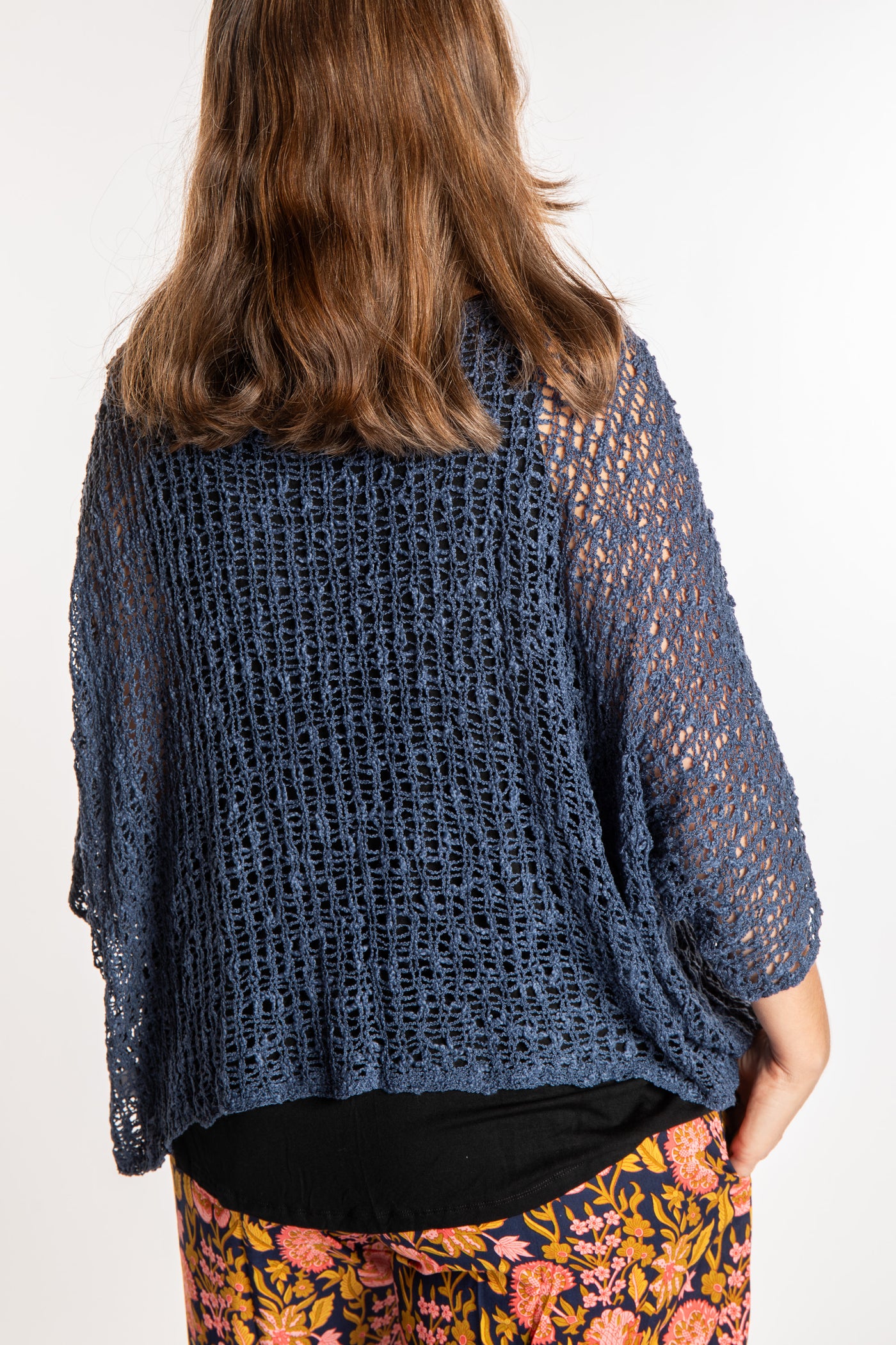 Holly wearing a Pacific Blue lightweight knitted poncho