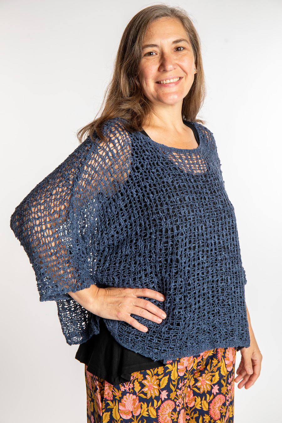 Holly wearing a Pacific Blue lightweight knitted poncho