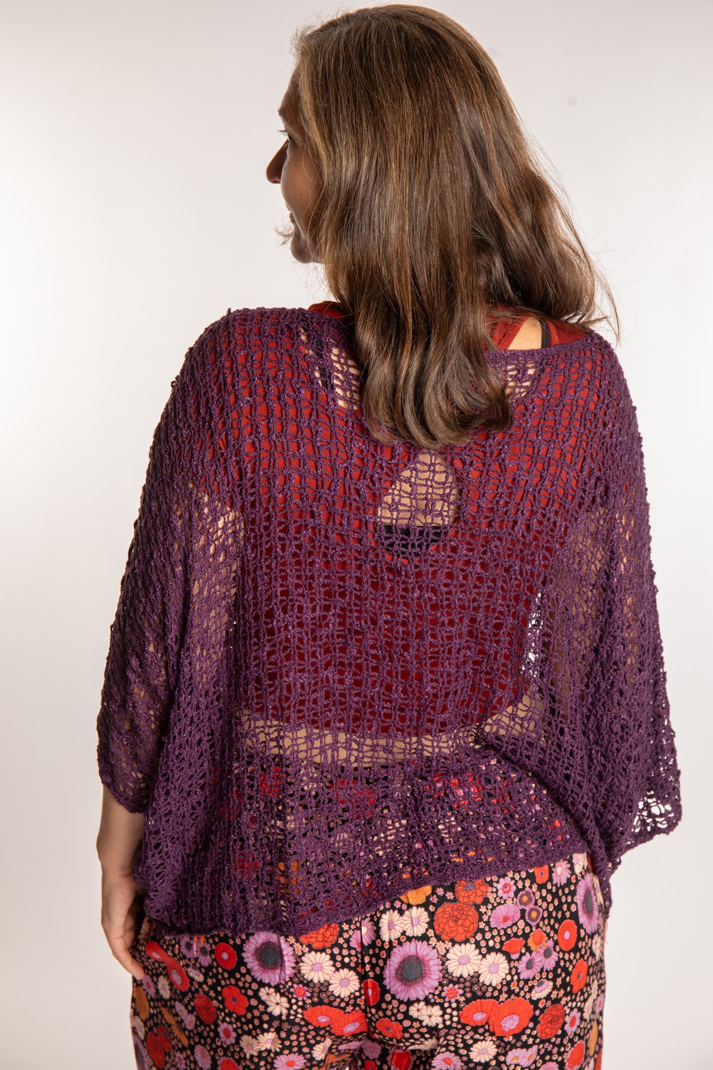 Holly wearing a Purple lightweight knitted poncho