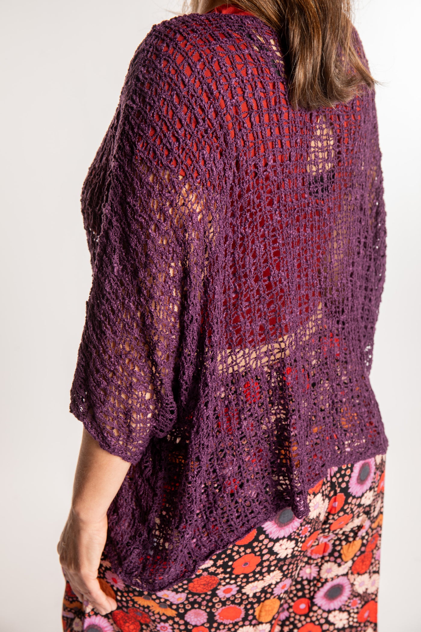 Holly wearing a Purple lightweight knitted poncho