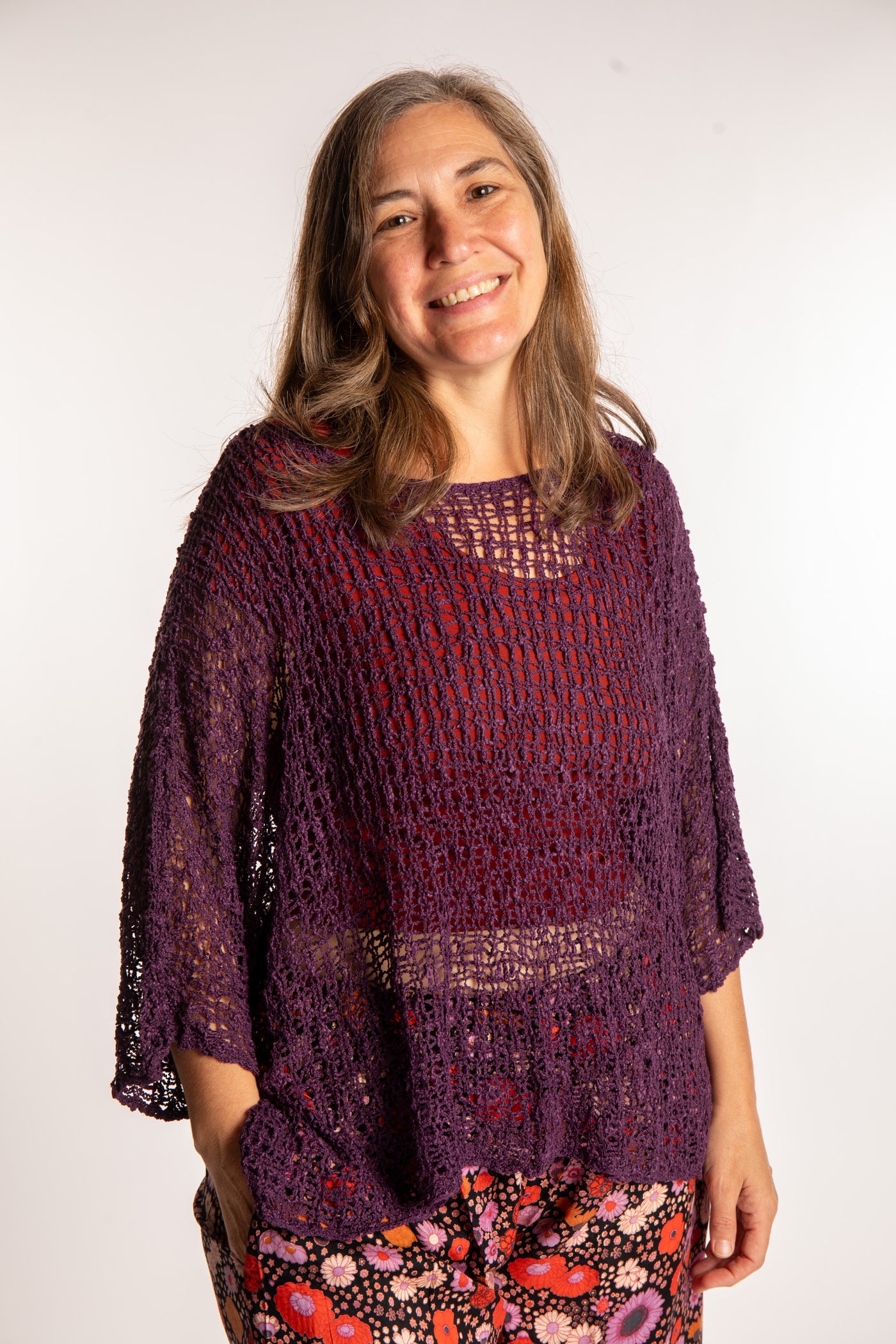 Holly wearing a Purple lightweight knitted poncho