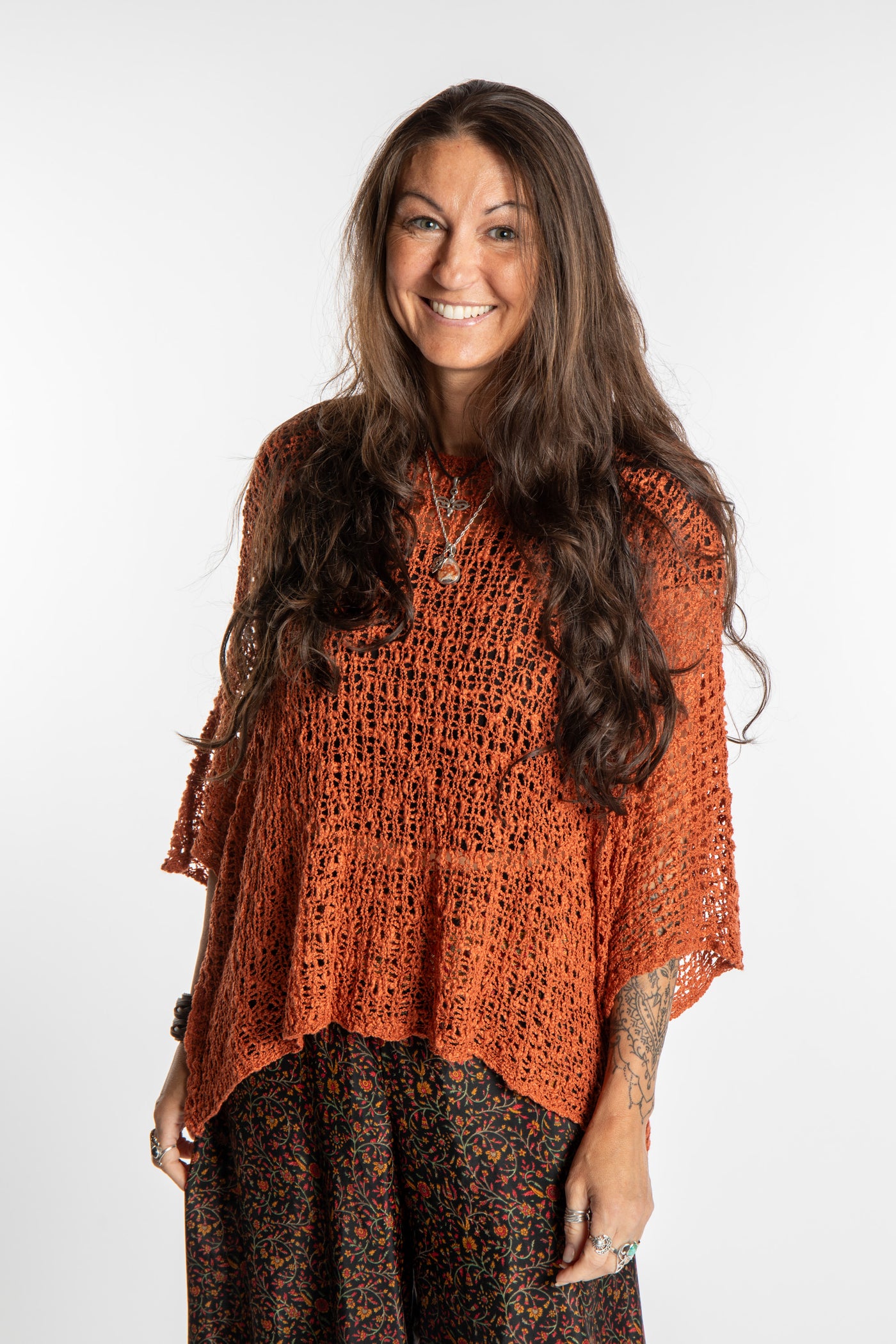 Jen wearing a Rust lightweight knitted poncho