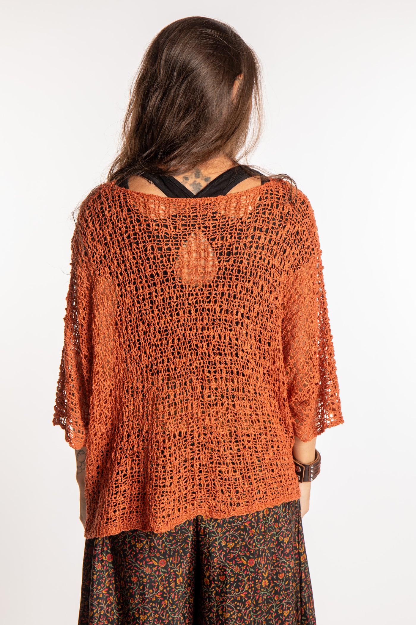 Jen wearing a Rust lightweight knitted poncho