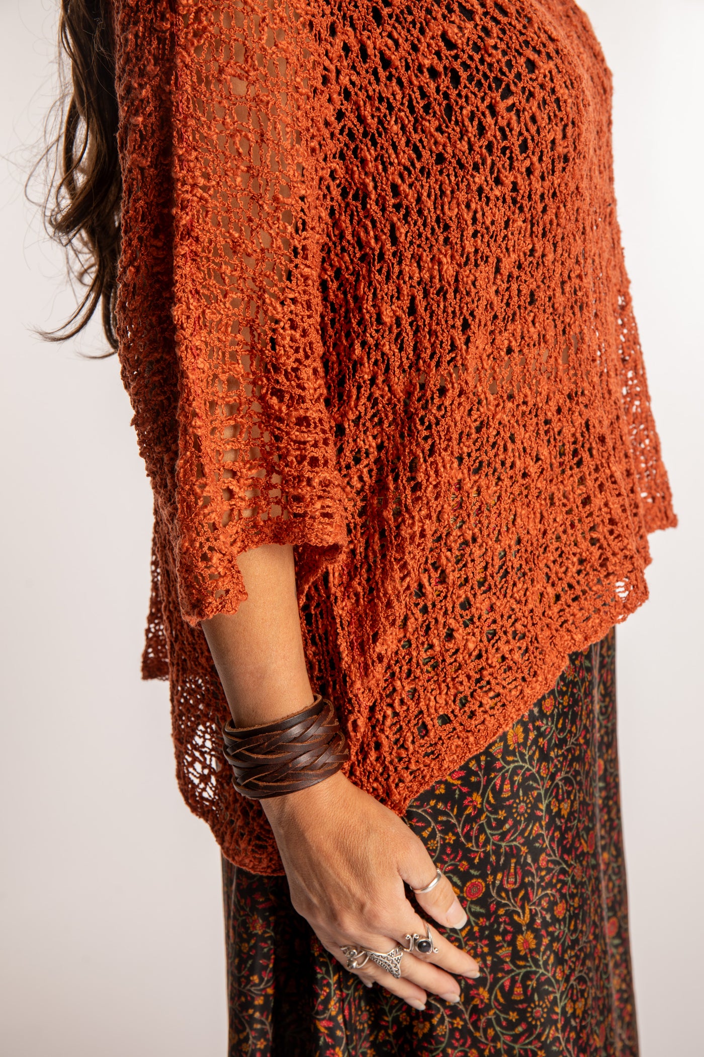 Jen wearing a Rust lightweight knitted poncho