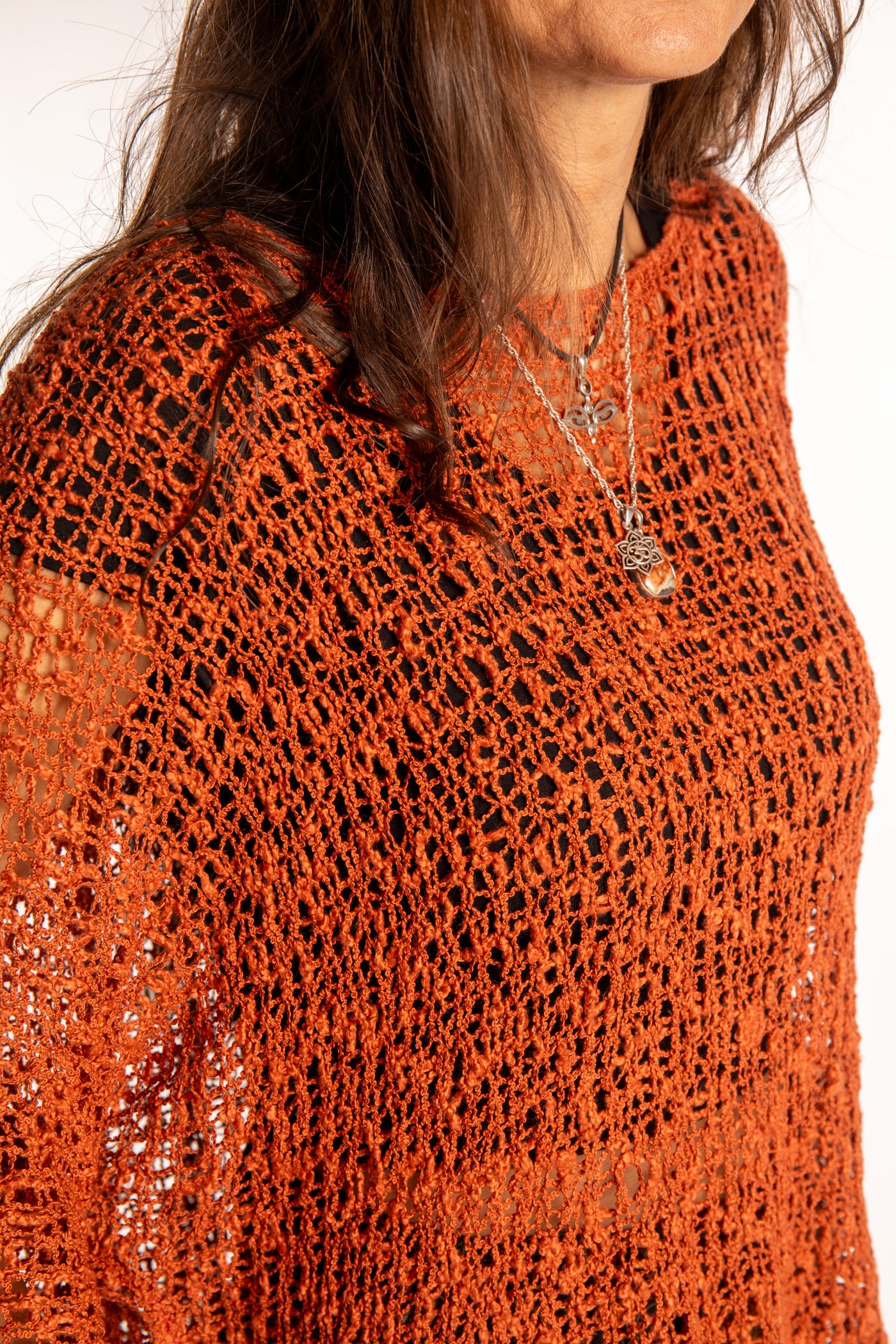 Jen wearing a Rust lightweight knitted poncho