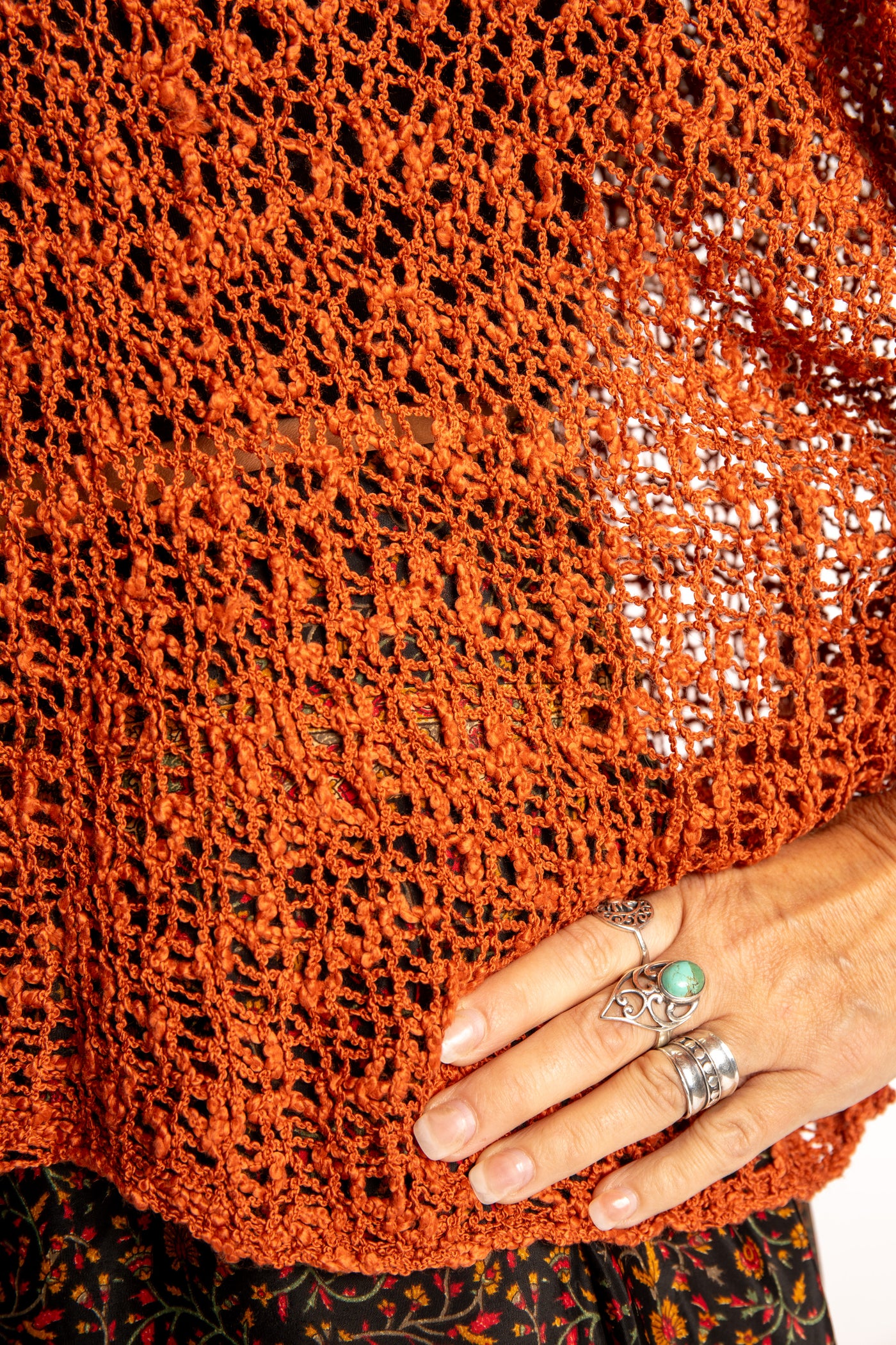 Jen wearing a Rust lightweight knitted poncho