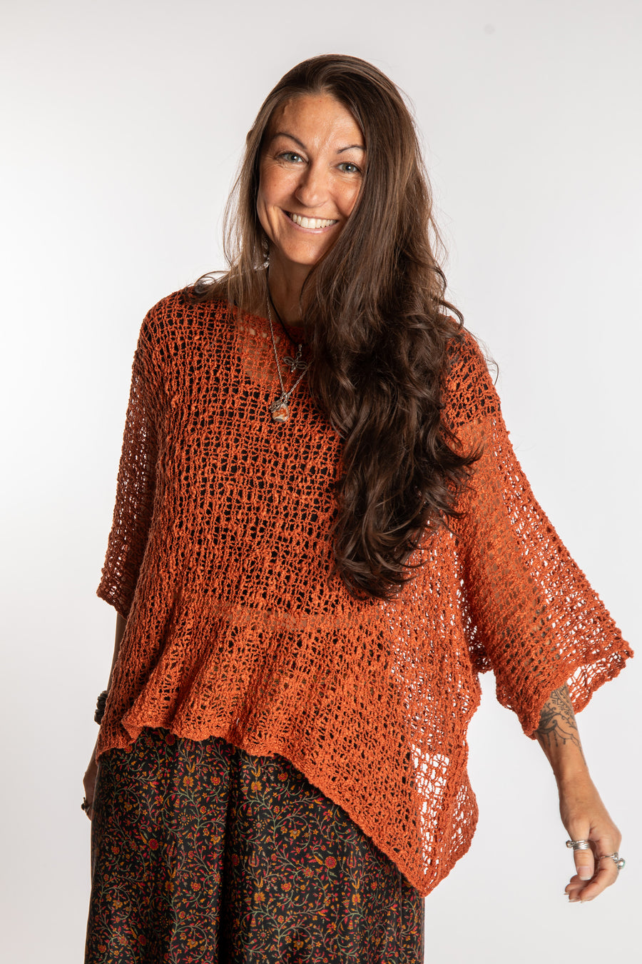 Jen wearing a Rust lightweight knitted poncho