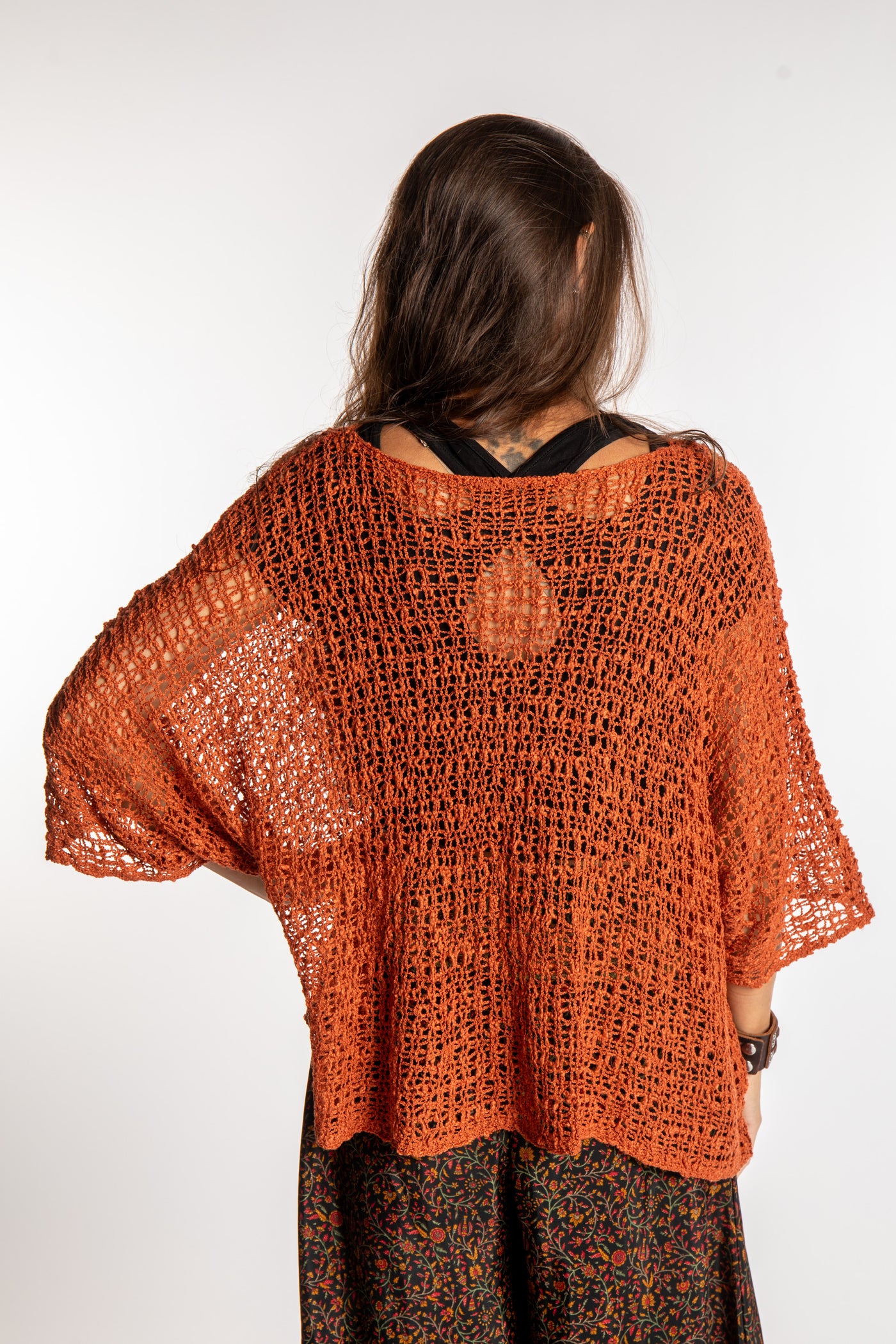 Jen wearing a Rust lightweight knitted poncho