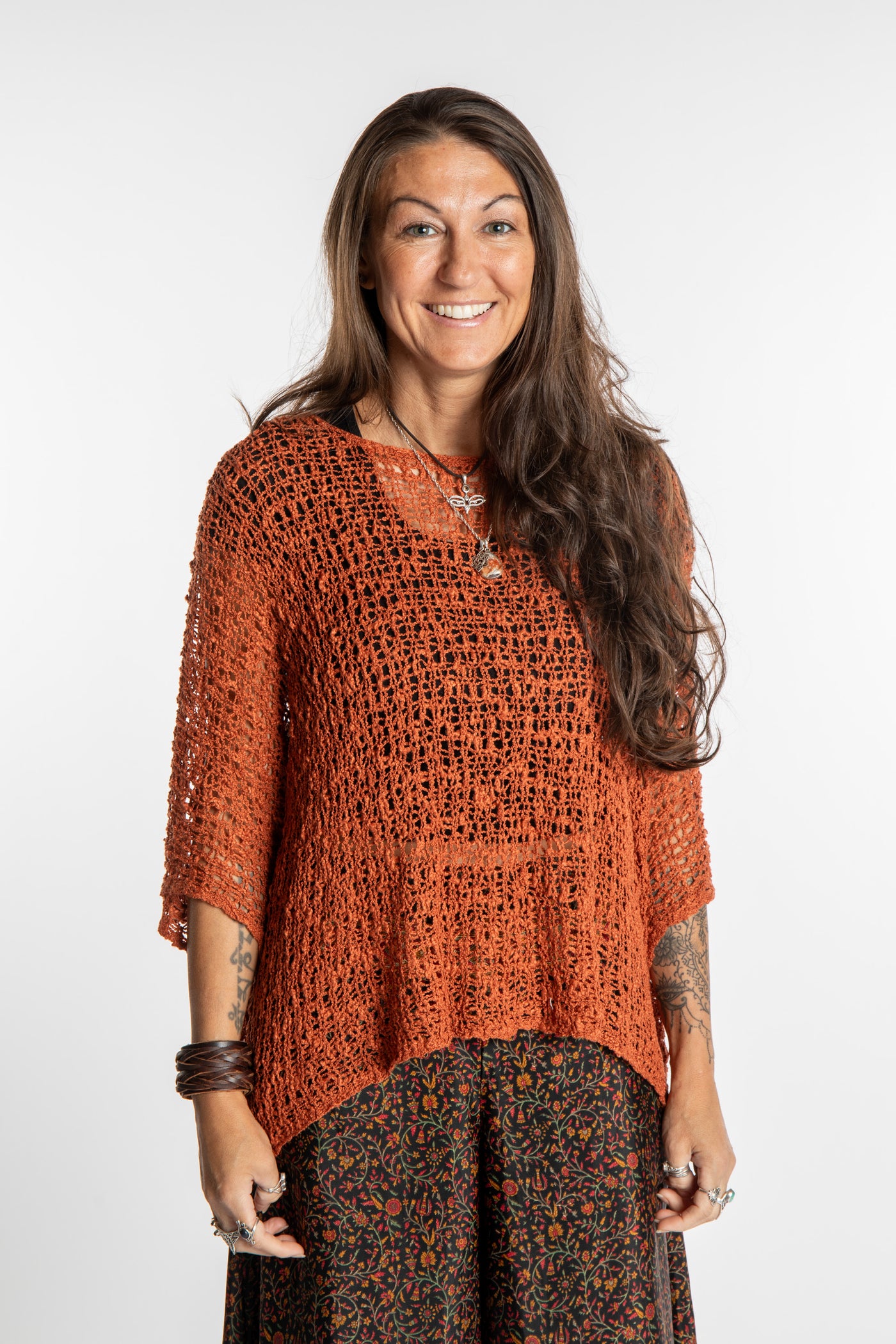 Jen wearing a Rust lightweight knitted poncho