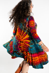 Susan wearing a orange long sleeve tie dye dress in the color Ocean