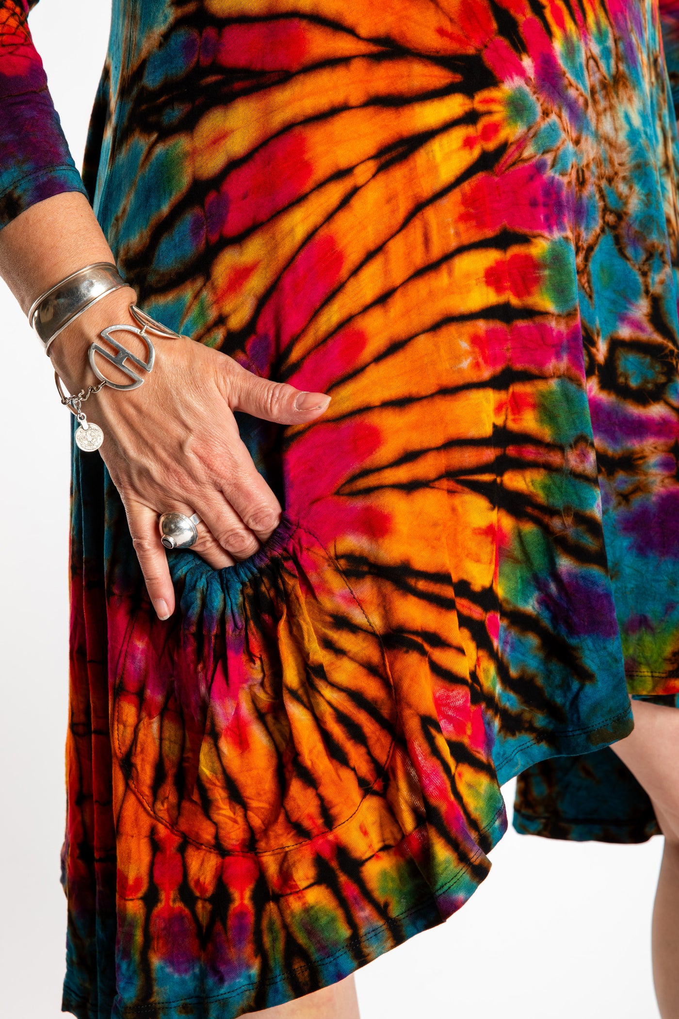 Susan wearing a orange long sleeve tie dye dress in the color Ocean