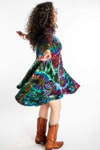 Susan wearing a blue long sleeve tie dye dress in the color Ocean