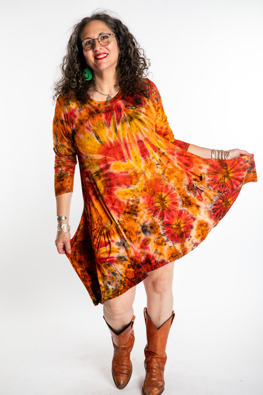 Susan wearing a orange long sleeve tie dye dress in the color Sunset