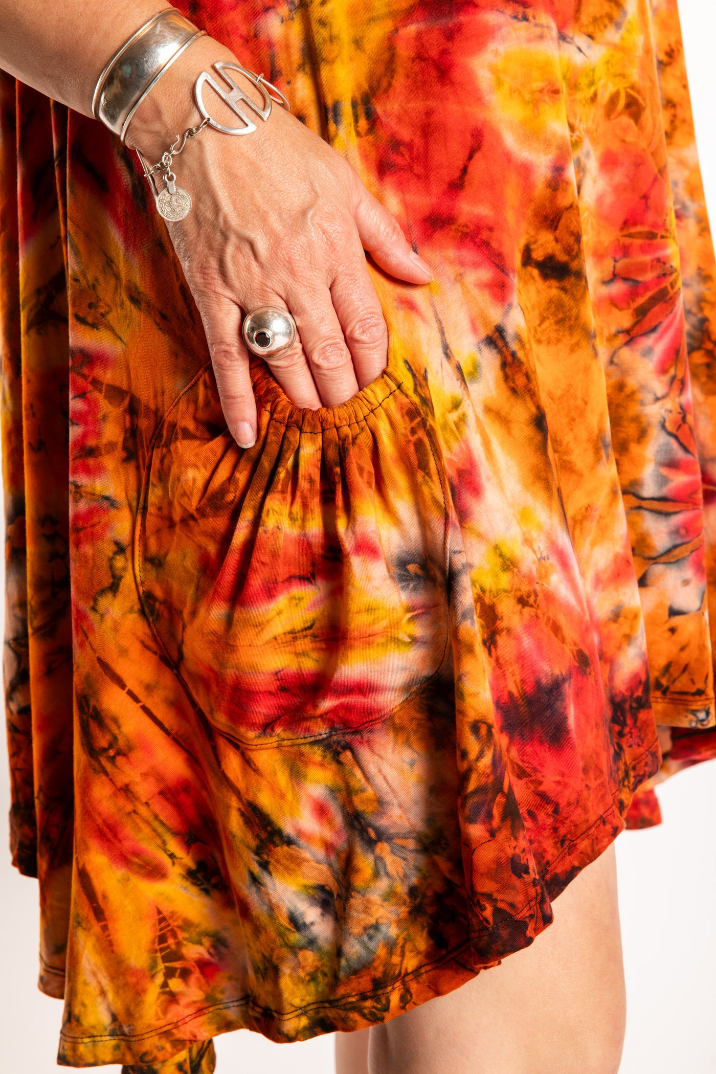 Susan wearing a orange long sleeve tie dye dress in the color Sunset
