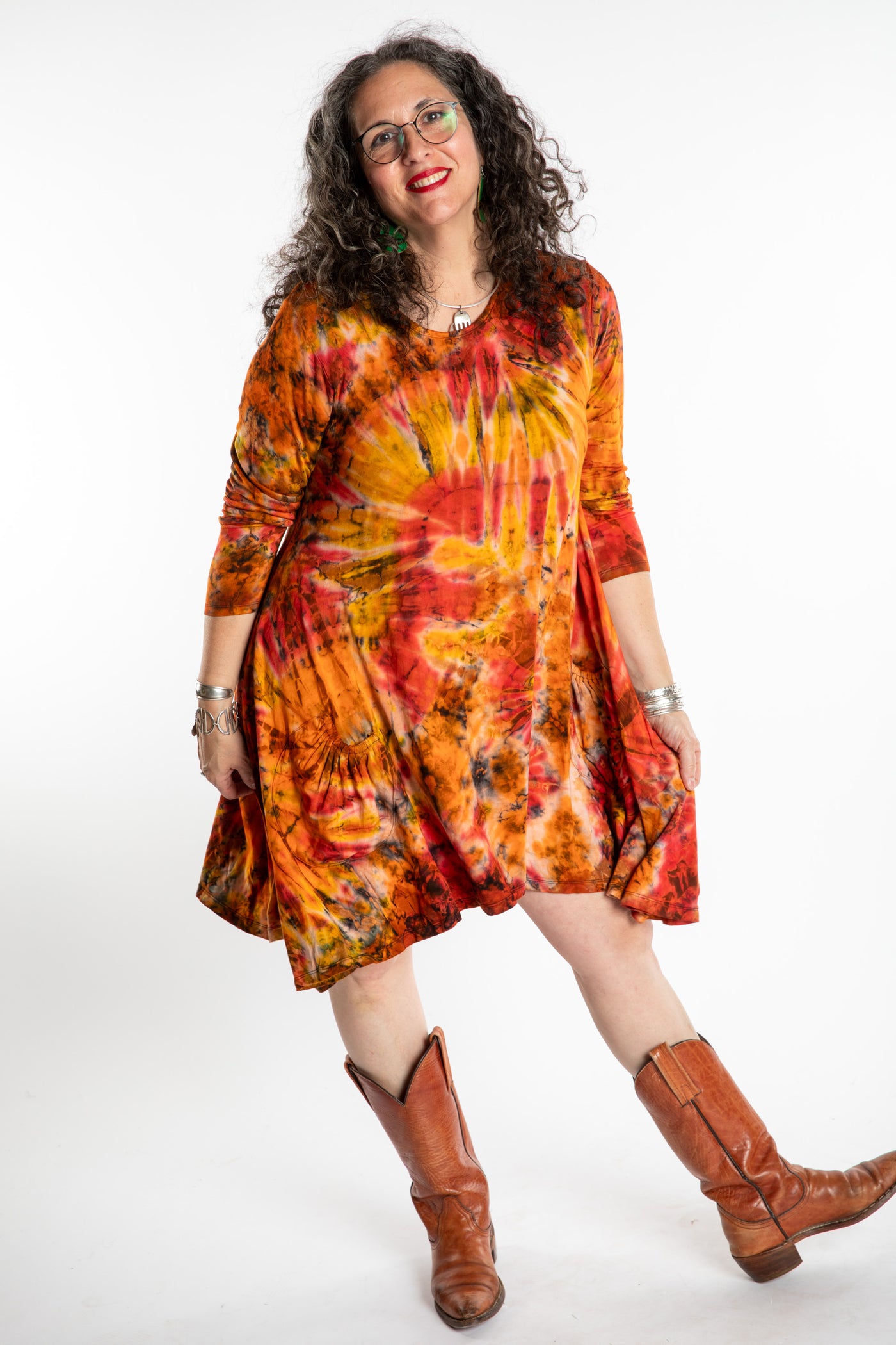 Susan wearing a orange long sleeve tie dye dress in the color Sunset