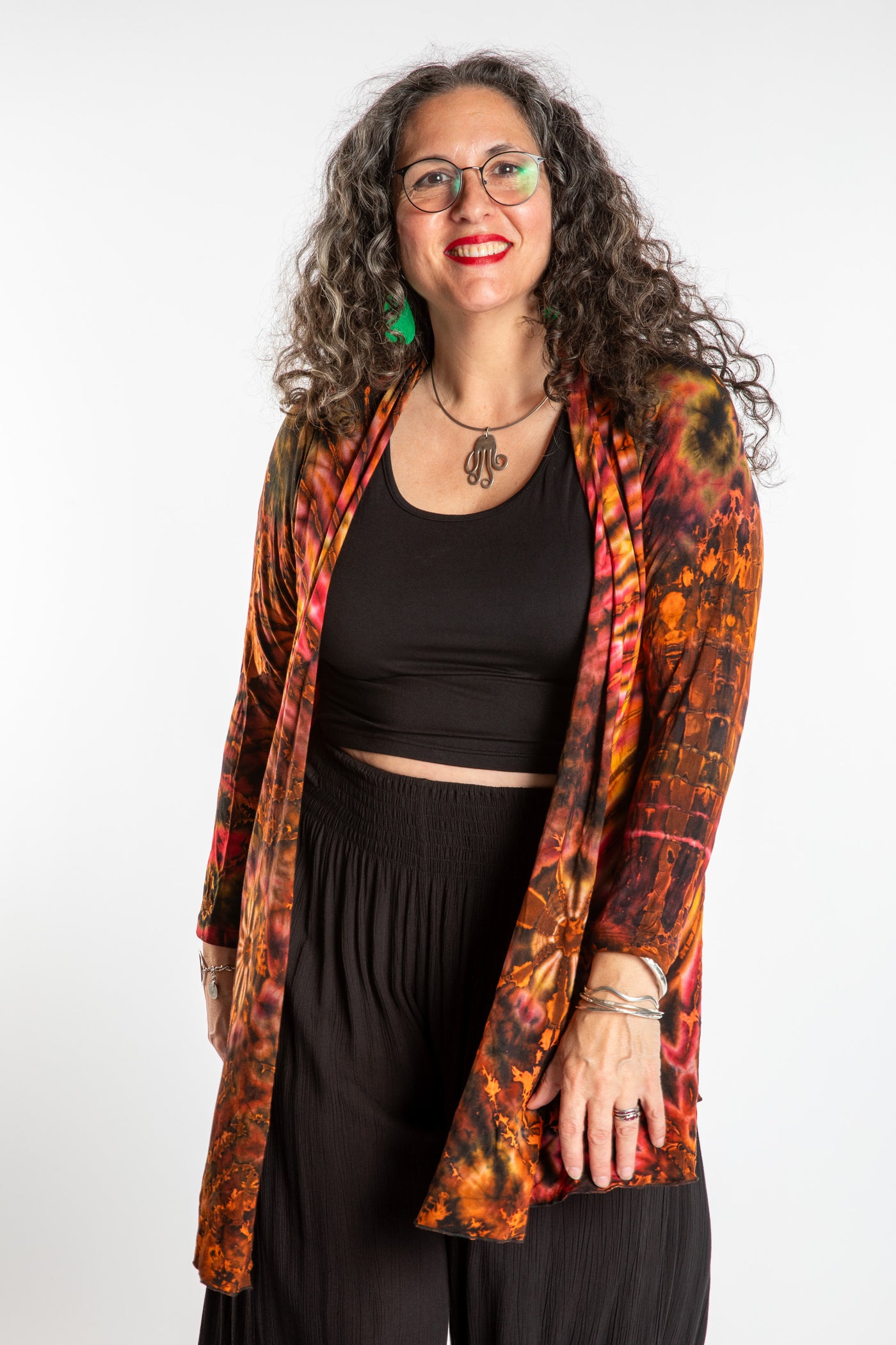 Susan wearing a orange sunset mudmee tie dye cardigan