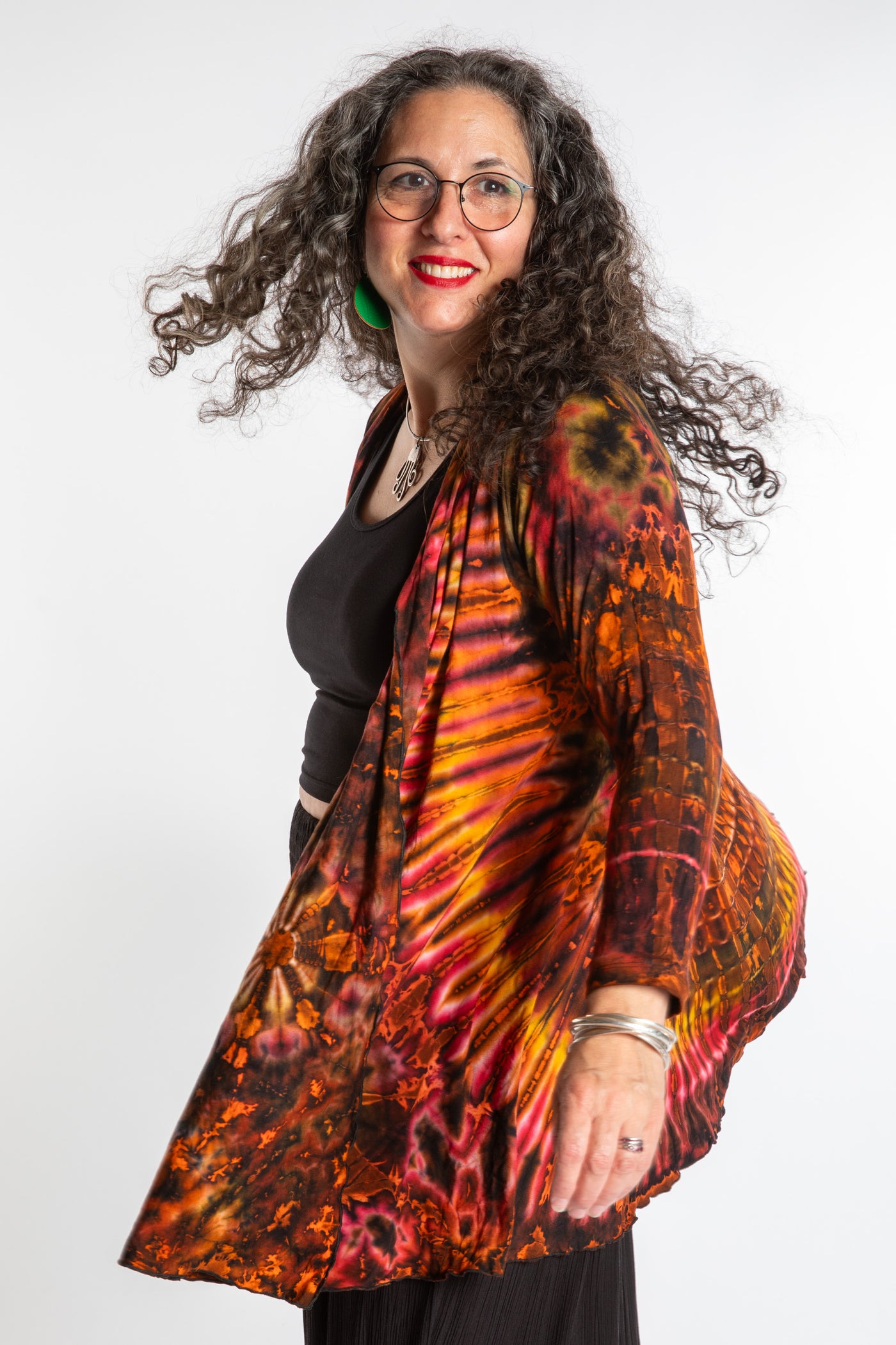 Susan wearing a orange sunset mudmee tie dye cardigan