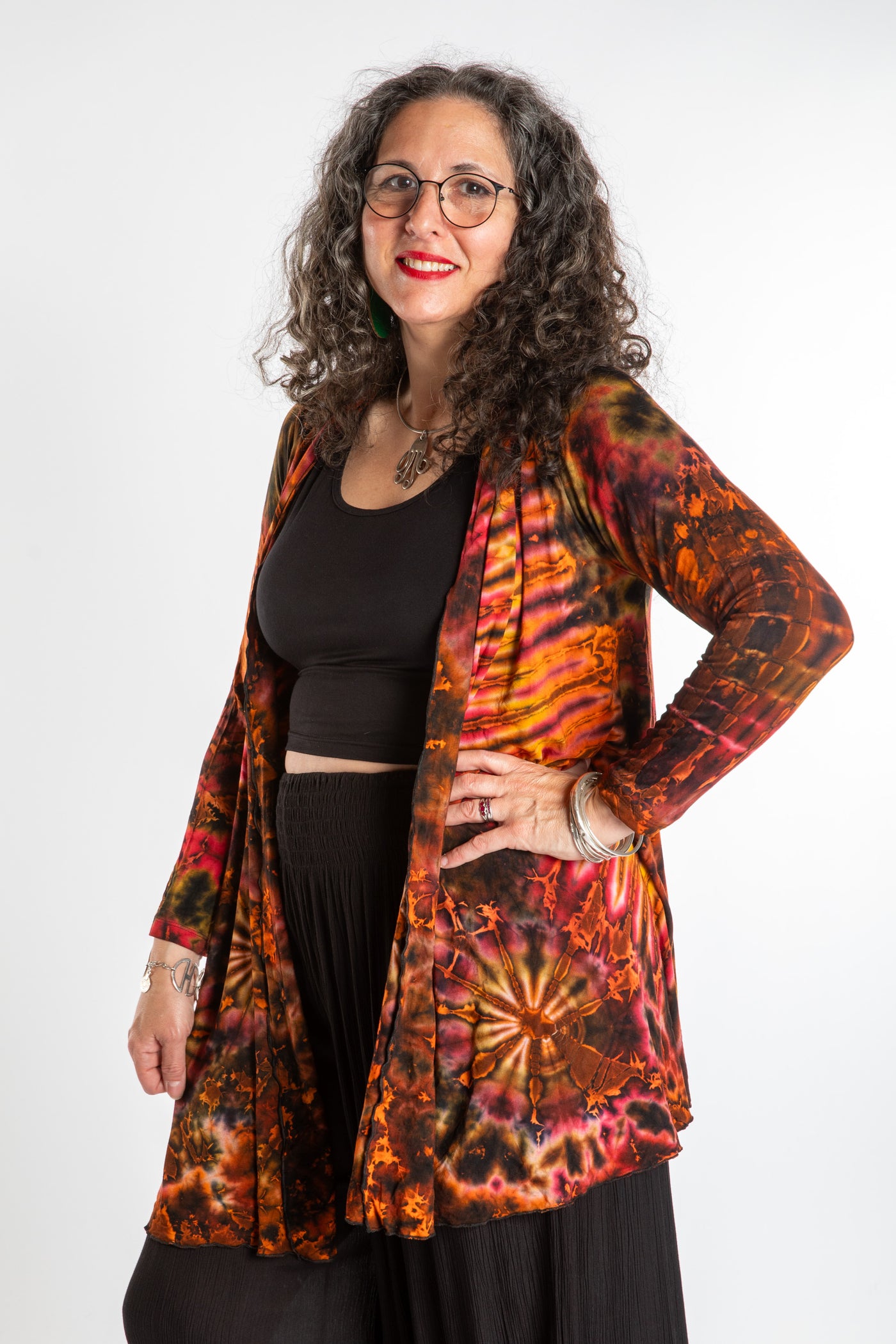 Susan wearing a orange sunset mudmee tie dye cardigan