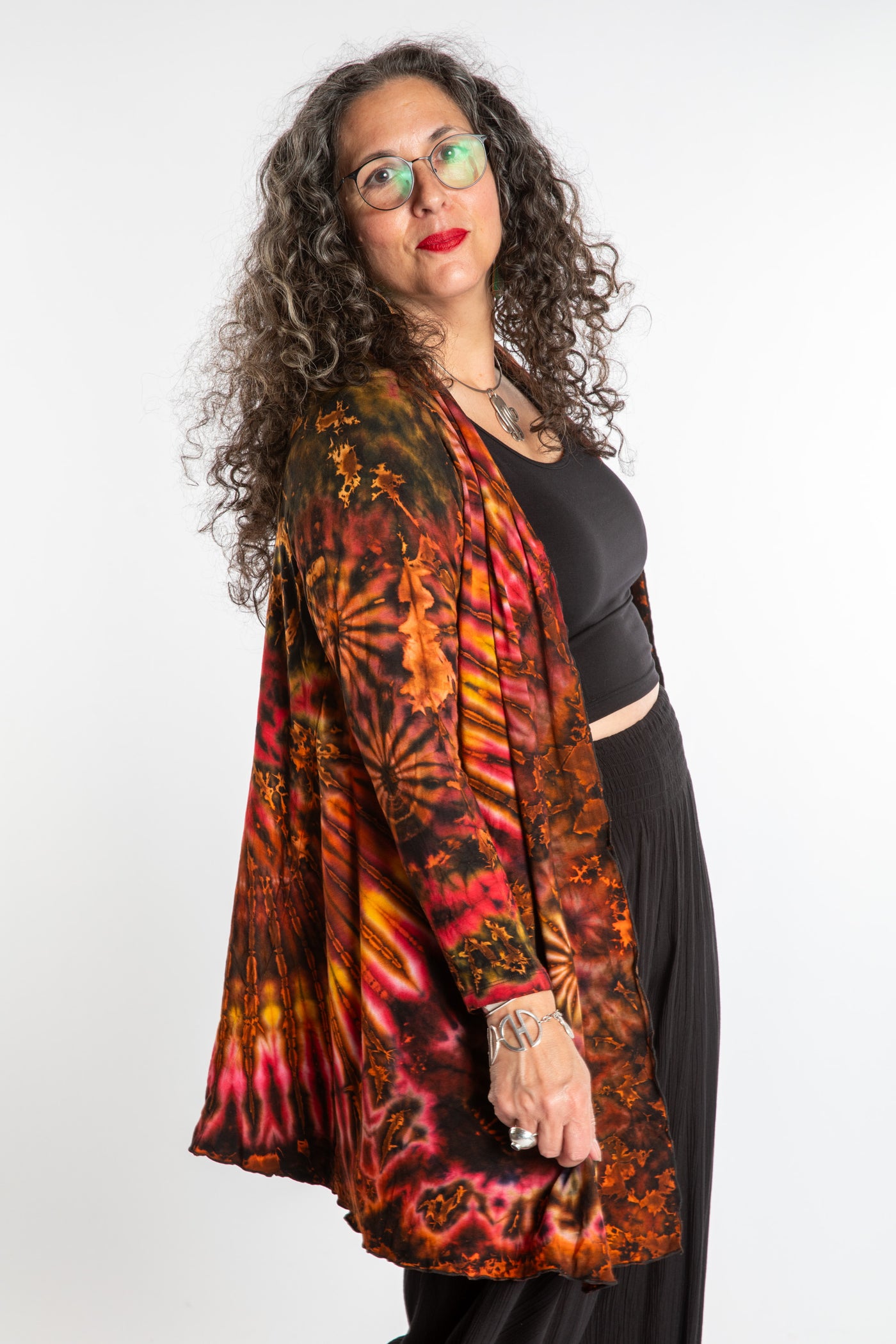 Susan wearing a orange sunset mudmee tie dye cardigan