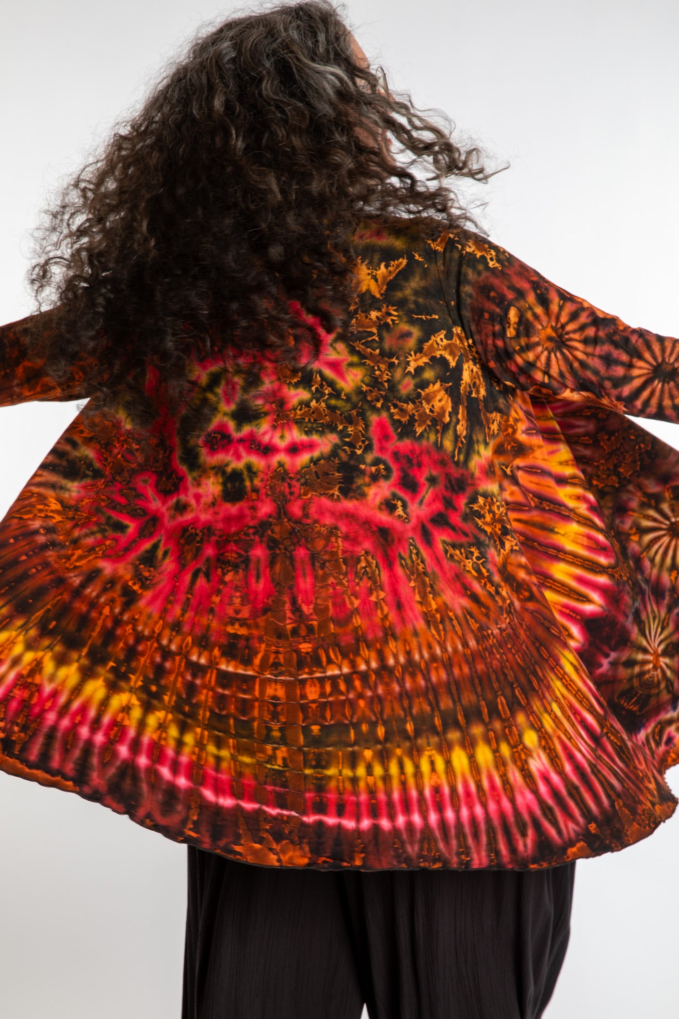 Susan wearing a orange sunset mudmee tie dye cardigan