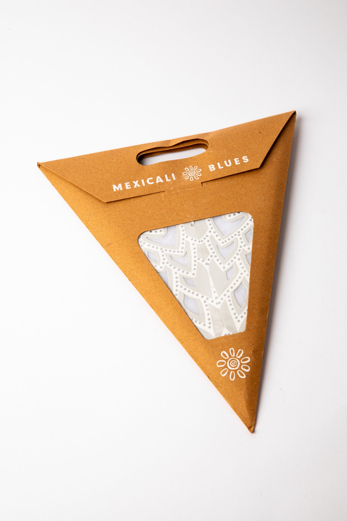 Silver embroidered paper star, folded up, in packaging