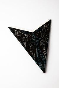 Blue and Black dotted embroidered paper star folded up, out of the package