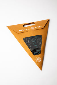 Blue and Black dotted embroidered paper star, folded up, in packaging