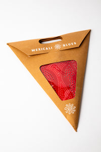 Red dotted embroidered paper star, folded up, in packaging