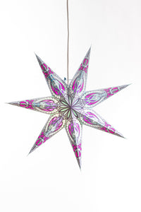A gray, pink, and purple, 7-pointed star lantern hanging in front of a white background. 
