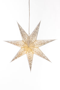 A white 7-point star lantern with an intricate design in front of a white backdrop. 
