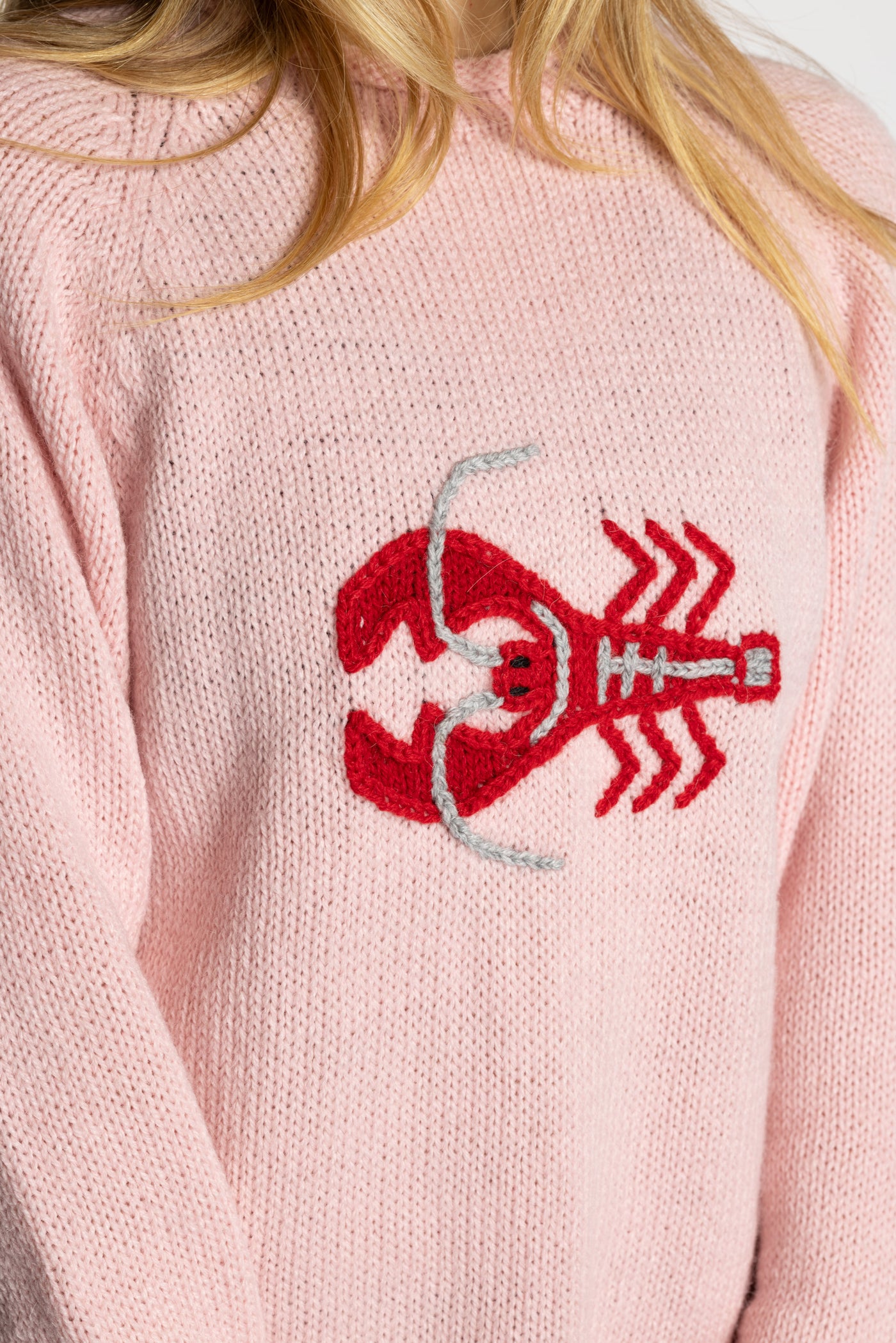 Sophie is wearing the Pink Lobster Alpaca Sweater in size S