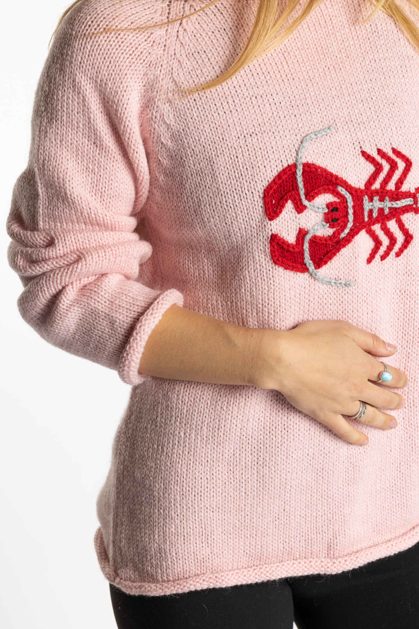 Sophie is wearing the Pink Lobster Alpaca Sweater in size S