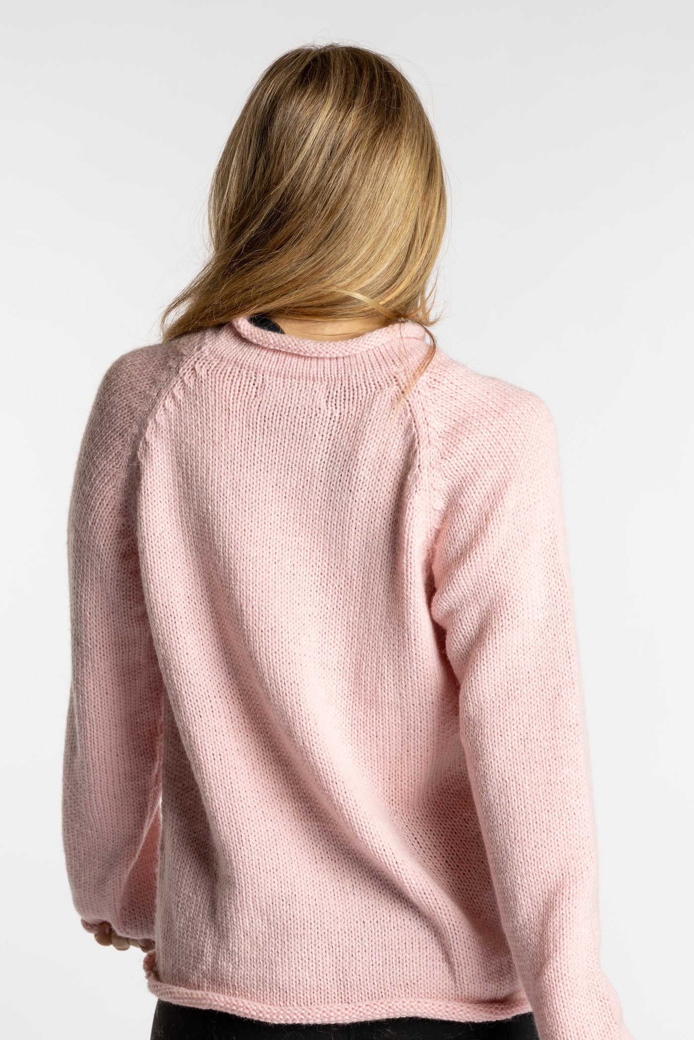 Sophie is wearing the Pink Lobster Alpaca Sweater in size S
