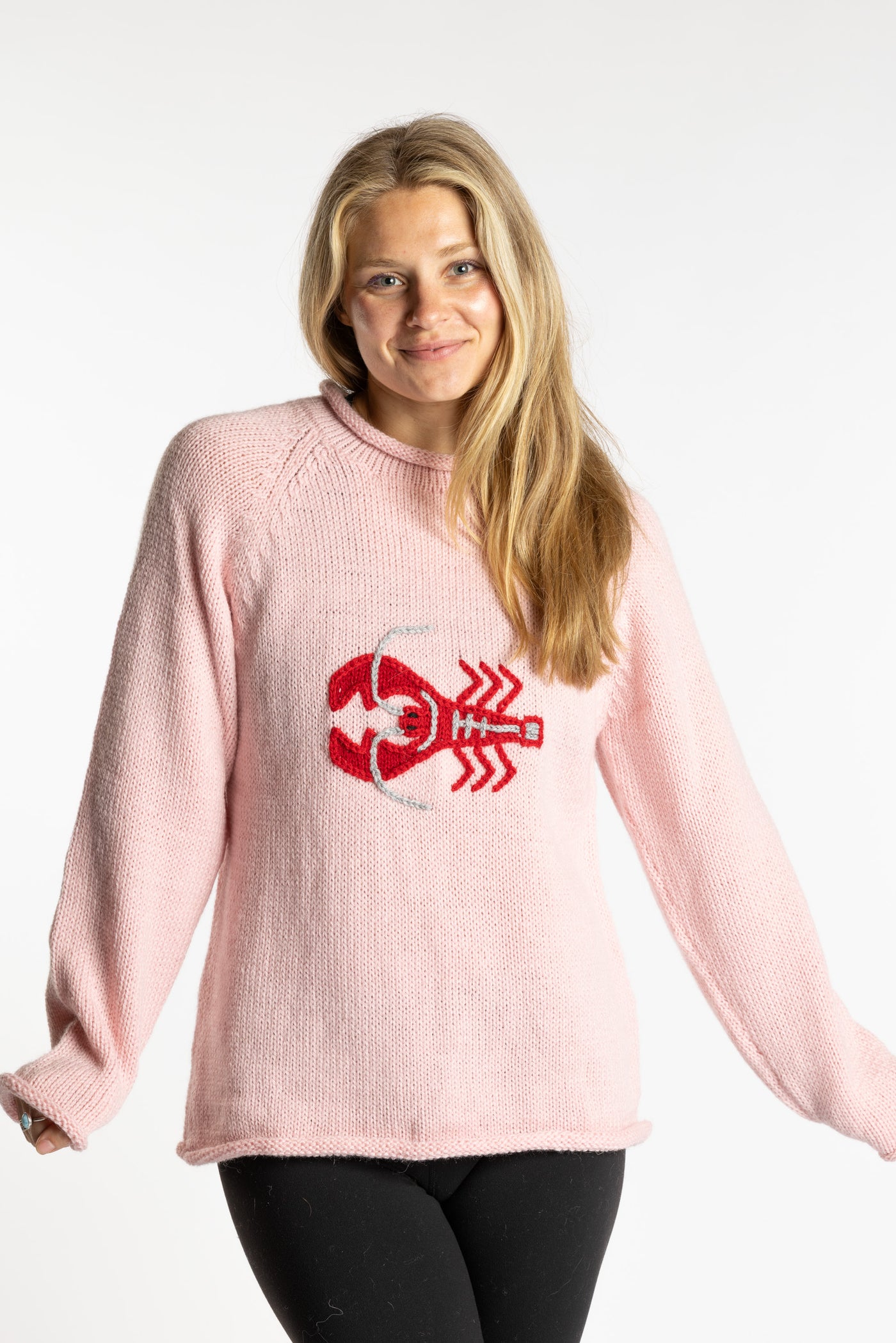 Sophie is wearing the Pink Lobster Alpaca Sweater in size S