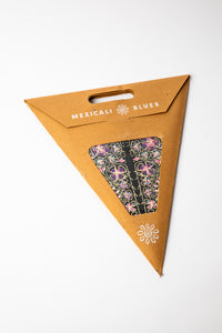 Pink and Black embroidered paper star, folded up, in packaging