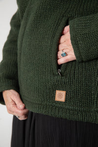 Detail of zipper pocket on dark green wool hooded jacket