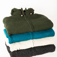 stack of wool hooded jackets to show off the different color possibilities