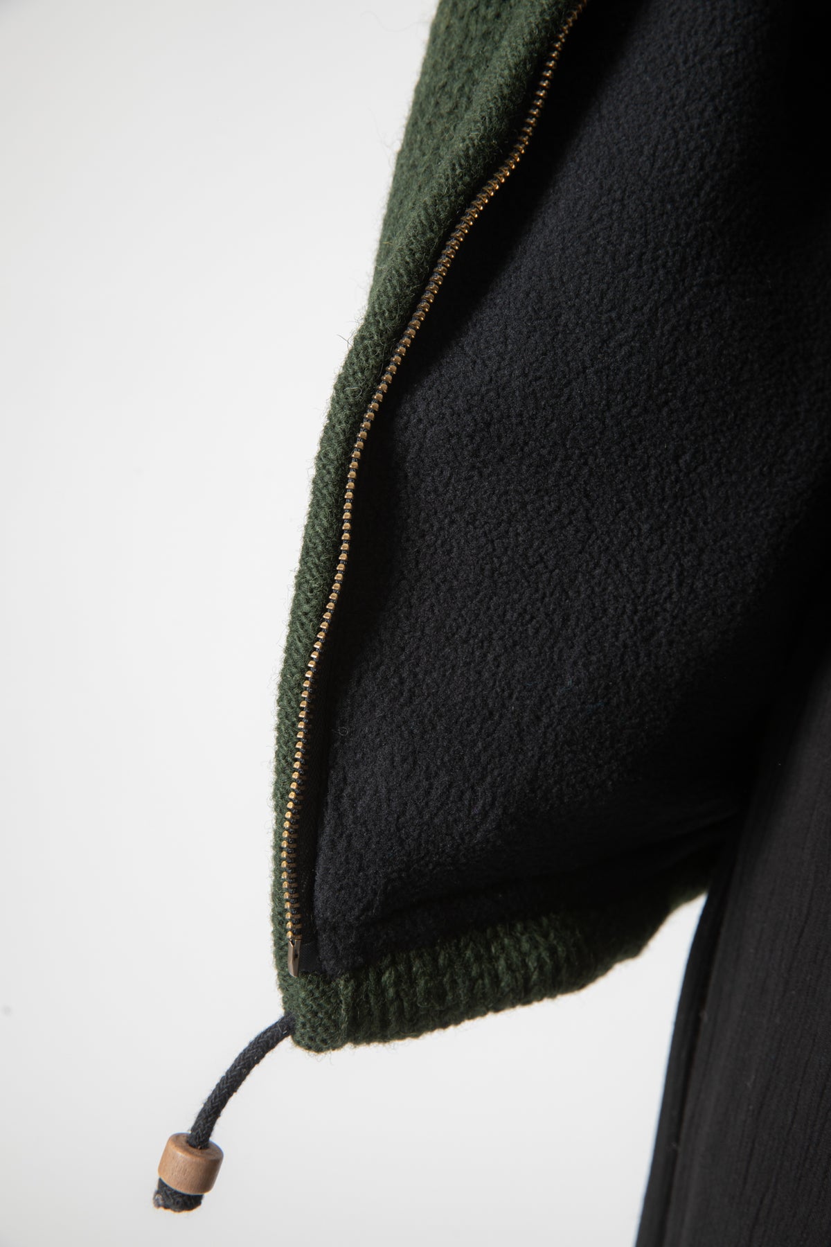 Detail of drawstring and zipper on Olive green wool hooded jacket