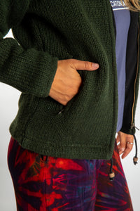 detail of pocket on dark green wool hooded jacket